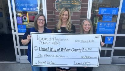 Jamie Soncrant, manager of the Walmart Neighborhood Market at 2700 Ward Blvd., left, presents a $1,000 Spark Good local grant check to United Way of Wilson County Executive Director Judi Thurston, center, and Resource Development Director Olivia Neeley, right. 